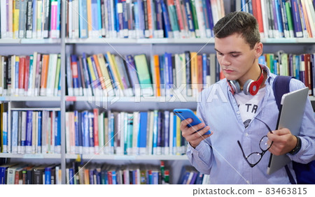 the student uses a notebook, latop and a school library 83463815