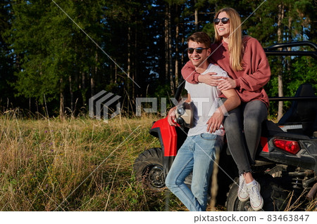 couple enjoying beautiful sunny day while driving a off road buggy couple enjoying beautiful sunny day while driving a off road buggy 83463847