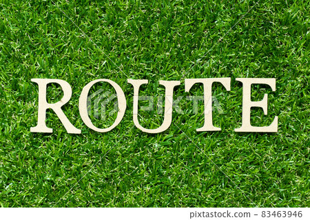 Wood letter in word route on green grass background 83463946