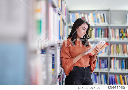 the student uses a notebook and a school library the student uses a notebook and a school library 83463960