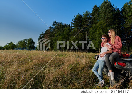 couple enjoying beautiful sunny day while driving a off road buggy couple enjoying beautiful sunny day while driving a off road buggy 83464317