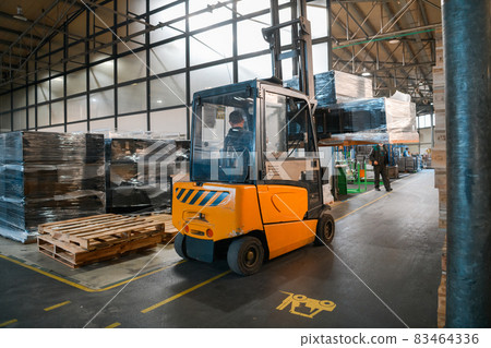 Forklift loader in storage warehouse ship yard. Distribution products. Delivery. Logistics. Transportation. Business background Forklift loader in storage warehouse ship yard. Distribution products. Delivery. Logistics. Transportation. Business background 83464336
