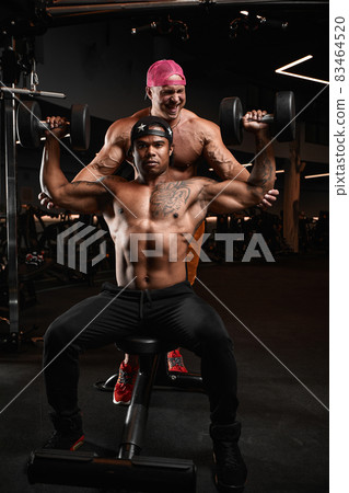 brutal sexy strong bodybuilders athletic fitness men pumping up abs muscles workout bodybuilding concept background 83464520