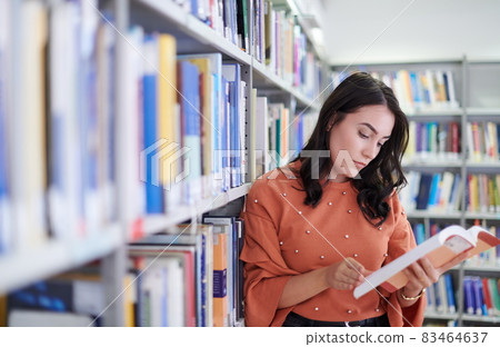 the student uses a notebook and a school library the student uses a notebook and a school library 83464637
