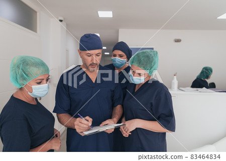 orthopedic doctor working together with his multiethnic team orthopedic doctor working together with his multiethnic team 83464834