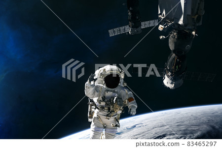 Astronaut and space station orbiting planet Earth. Solar system 83465297