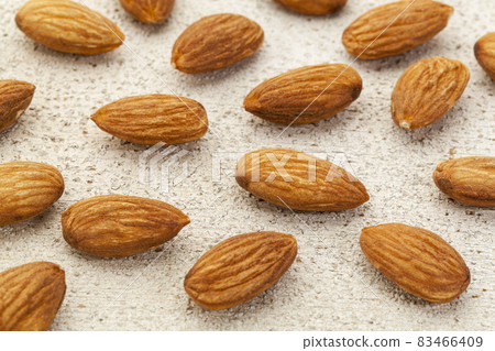 raw almonds on white wood 83466409