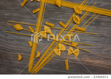 top view Various types of Italian pasta on wooden background top view Various types of Italian pasta on wooden background 83466831