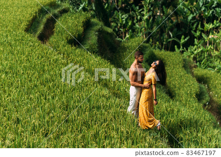 A man and a woman among the rice terraces. A couple in love travels through Asia. Man and woman are traveling in Bali. Happy couple in Bali. The couple travels the world. Rice terraces in Bali. A man and a woman among the rice terraces. A couple in love travels through Asia. Man and woman are traveling in Bali. Happy couple in Bali. The couple travels the world. Rice terraces in Bali. 83467197