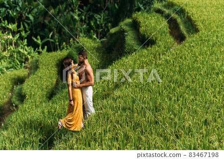 A man and a woman among the rice terraces. A couple in love is traveling in Asia. A man and a woman are traveling in Indonesia. Happy couple in Bali. Rice terraces in Bali. Copy space 83467198