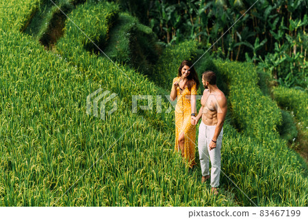 A man and a woman among the rice terraces. A couple in love travels through Asia. Man and woman are traveling in Bali. Happy couple in Bali. The couple travels the world. Rice terraces in Bali. A man and a woman among the rice terraces. A couple in love travels through Asia. Man and woman are traveling in Bali. Happy couple in Bali. The couple travels the world. Rice terraces in Bali. 83467199
