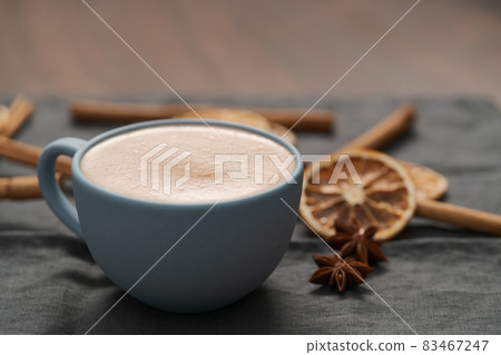 Hot chocolate in a blue cup with natural christmas decorations Hot chocolate in a blue cup with natural christmas decorations 83467247