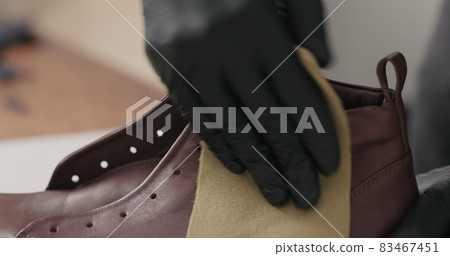 Man maintenance cleaning shoes closeup Man maintenance cleaning shoes closeup 83467451