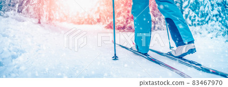 Skier foots in skis in the snowy winter forest Skier foots in skis in the snowy winter forest 83467970