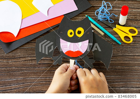 The child plays of dracola bat toy Halloween. Children's art project, craft for children. Craft for kids. 83468005