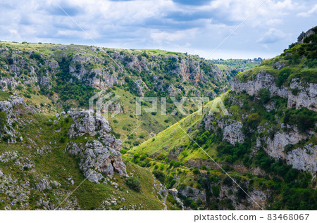 View of canyon with rocks and caves Murgia Timone, Matera Sassi, Italy 83468067
