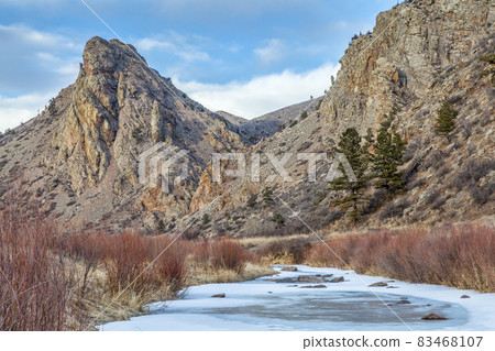 frozen stream and landmark rock 83468107