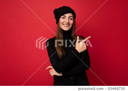 Portrait of beautiful fascinating emotional positive joyful happpy female promoter pointing to the 83468730