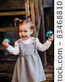 smilling girl holding christmas toys 83468810