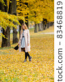 Woman in autumn park 83468819