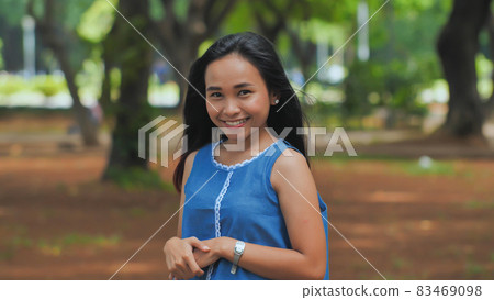 Portrait of a smiling Indonesian girl in a park 83469098