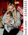 mom hugs daughter on christmas background 83469165