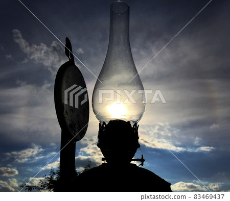 Old kerosene lamp burning with bright sun flame Old kerosene lamp burning with bright sun flame 83469437