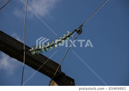 Power lines on background of blue sky close-up. Electric hub on pole. Electricity equipment with copy space. Wires of high voltage in sky 83469981