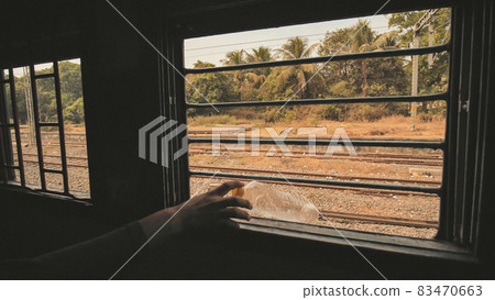 Indian people throw a plastic bottle and garbage from the train window. Video slow motion. 83470663