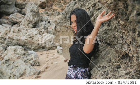 Indonesian girl posing on a beautiful and rocky beach in Bali. Idonezia. 83473681