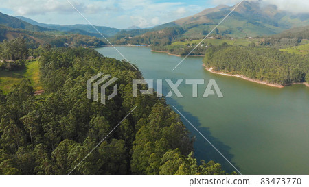 Aerial view beautiful nature with mountains and hills by Lake Mattupetty. Kerala State. Near the city of Munar. 83473770