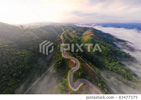 Aerial top view of sky road over top of mountain with fog and green jungle morning ,Phu Kao Ngom LOEI thailand 83477375
