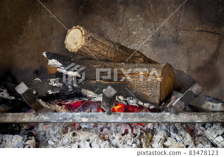 fireplace with burning wood logs 83478123