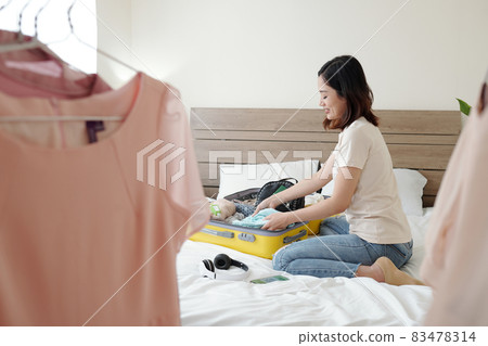 Woman Packing Summer Clothes 83478314