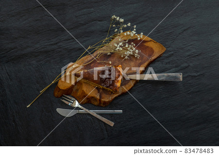 Slice of delicious fresh Tartellette creme brulee a la vanille on a wooden plate. Slice of delicious fresh Tartellette creme brulee a la vanille on a wooden plate. 83478483