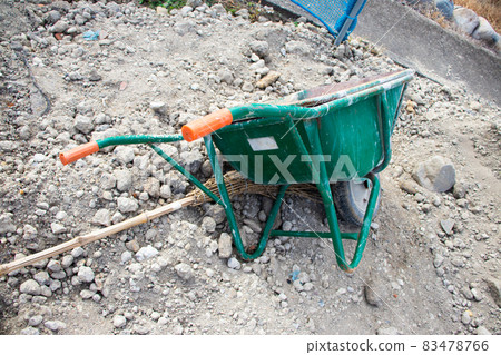 A unicycle lying on the construction site 83478766