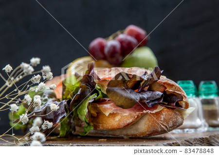 A delicious Smoked salmon sesame bread sandwich on a wooden plate. A delicious Smoked salmon sesame bread sandwich on a wooden plate. 83478848