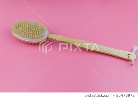 Massage brush on a pink background Massage brush on a pink background 83478972