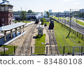 The locomotive departs from the railway station on a sunny summer morning 83480108