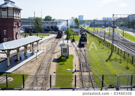 The locomotive departs from the railway station on a sunny summer morning The locomotive departs from the railway station on a sunny summer morning 83480108