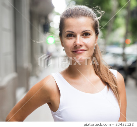 City portrait of cheerful girl 83482128