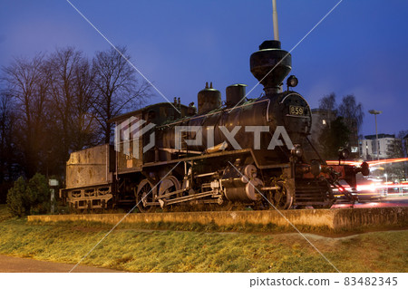 KOUVOLA, FINLAND - NOVEMBER 8, 2018: Old steam locomotive as an exhibit at the Kouvola railway station in Finland at night. 83482345