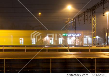 KOUVOLA, FINLAND - NOVEMBER 7, 2018: Train in motion on the station at night, long exposure photo. KOUVOLA, FINLAND - NOVEMBER 7, 2018: Train in motion on the station at night, long exposure photo. 83482380