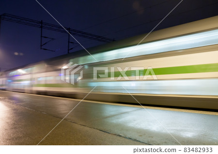 Train in motion on the station at night, long exposure photo. Train in motion on the station at night, long exposure photo. 83482933