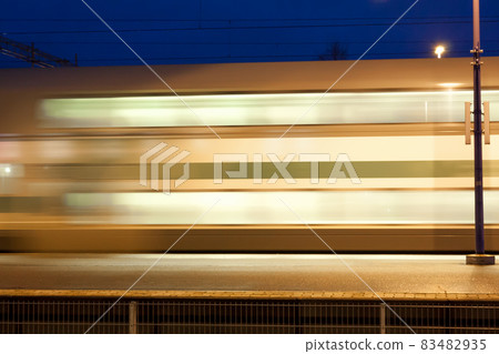 Train in motion on the station at night, long exposure photo. 83482935