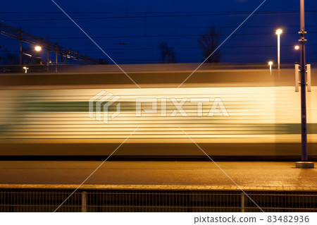 Train in motion on the station at night, long exposure photo. 83482936