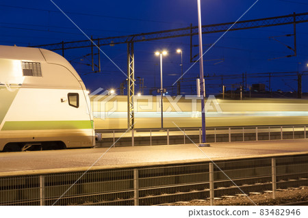 Train in motion on the station at night, long exposure photo. 83482946