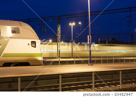 Train in motion on the station at night, long exposure photo. 83482947