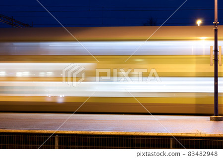 Train in motion on the station at night, long exposure photo. Train in motion on the station at night, long exposure photo. 83482948