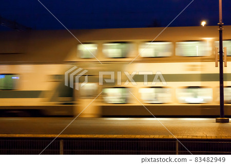 Train in motion on the station at night, long exposure photo. Train in motion on the station at night, long exposure photo. 83482949